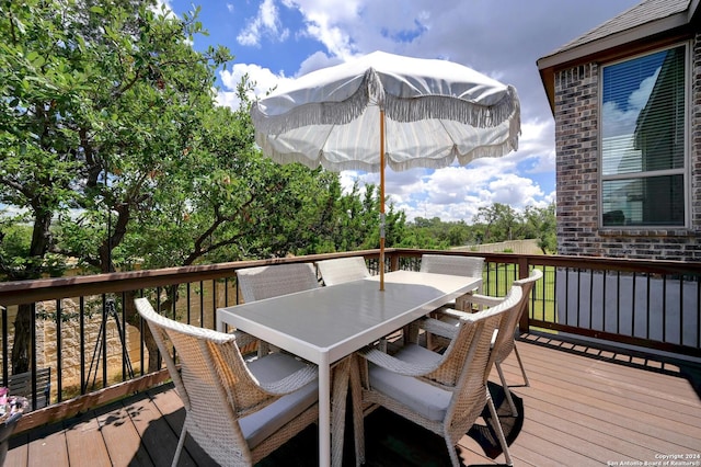 wooden terrace featuring outdoor dining space