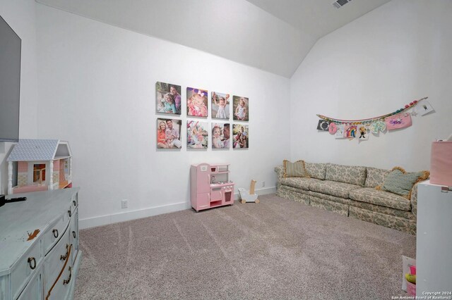 game room with light carpet and vaulted ceiling