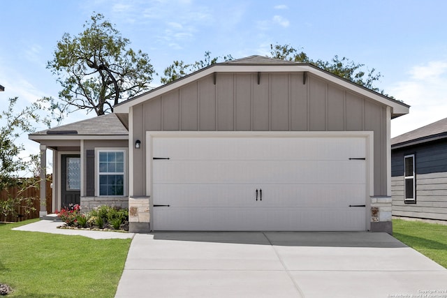 view of front of property with a front lawn and a garage