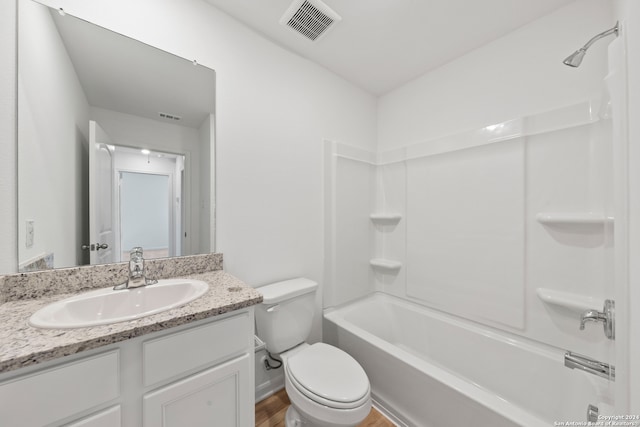 full bathroom featuring vanity, toilet, hardwood / wood-style flooring, and bathtub / shower combination