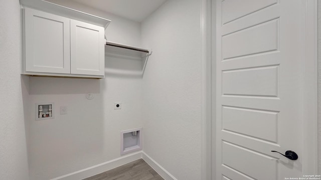 washroom featuring hookup for a gas dryer, cabinets, washer hookup, electric dryer hookup, and light hardwood / wood-style flooring