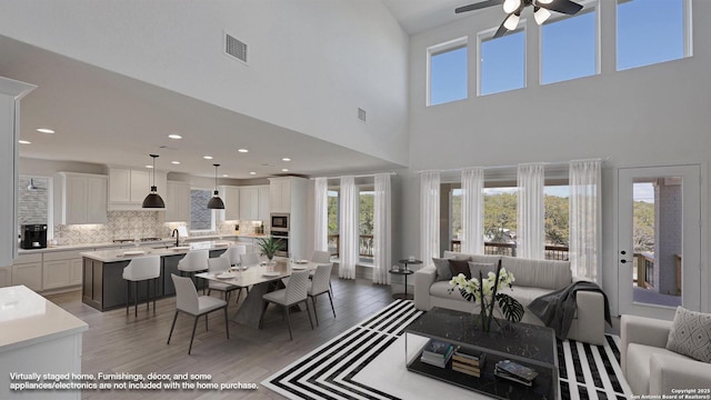 dining room with ceiling fan, light wood finished floors, visible vents, and recessed lighting