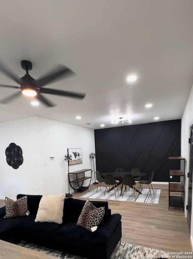 living room featuring ceiling fan and hardwood / wood-style flooring