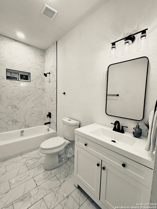 full bathroom featuring a textured ceiling, vanity, toilet, and tiled shower / bath combo