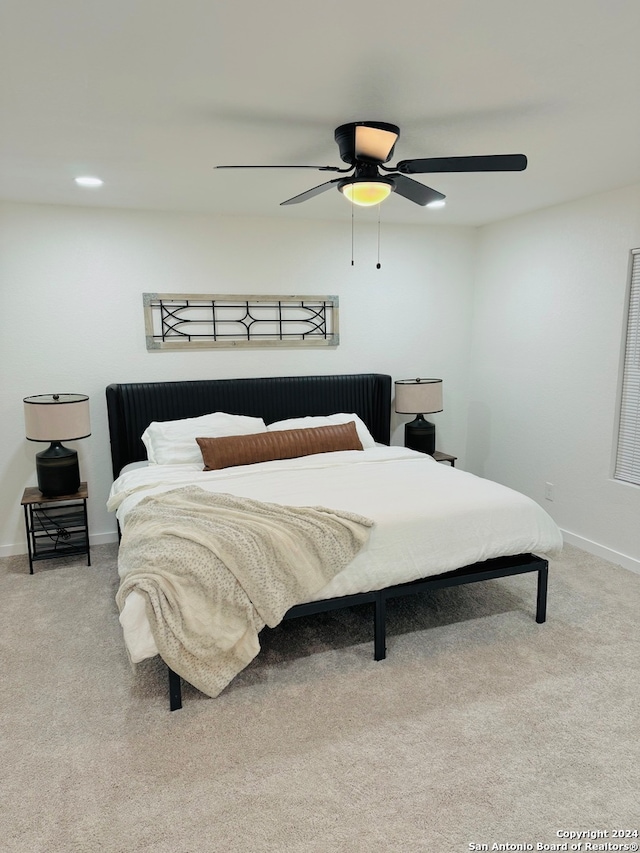 bedroom featuring ceiling fan and carpet