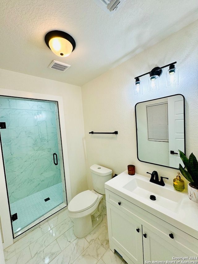 bathroom with a textured ceiling, vanity, toilet, and walk in shower