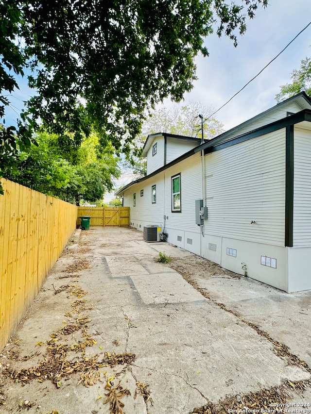 view of home's exterior featuring central AC unit and a patio