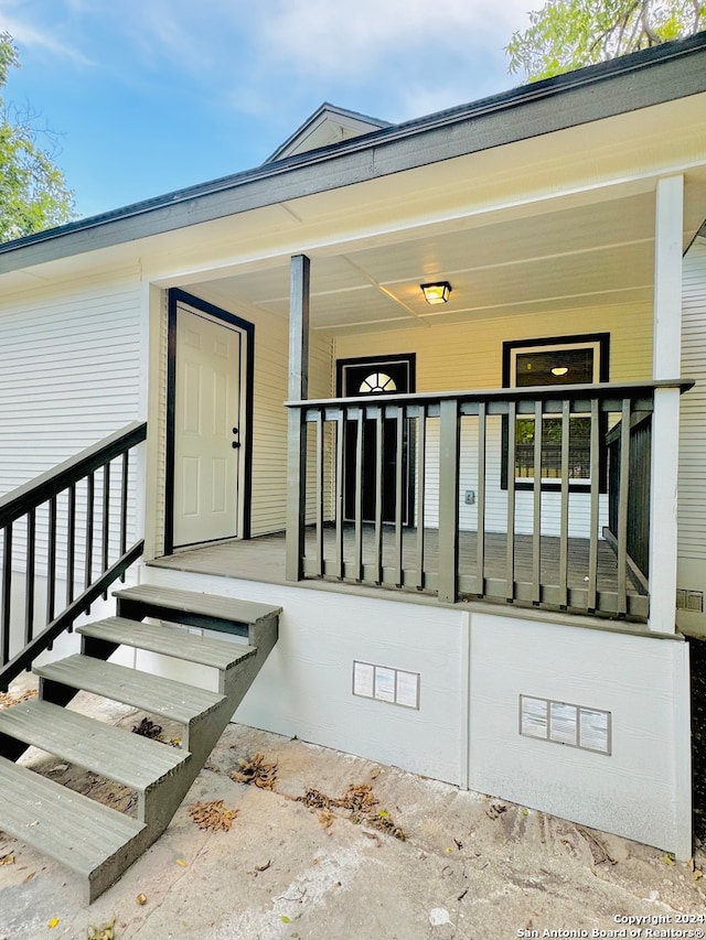 doorway to property featuring a porch