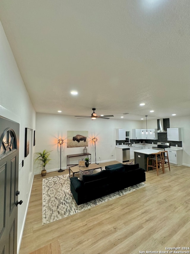 living room featuring light wood-type flooring and ceiling fan