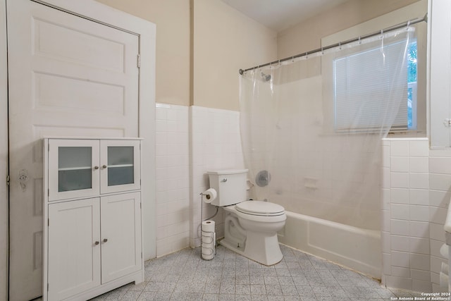 bathroom featuring tile walls, tile patterned flooring, toilet, and shower / tub combo