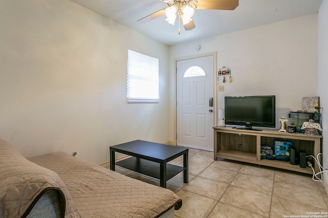 tiled living room with ceiling fan