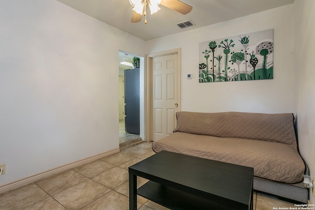 living room featuring light tile patterned floors and ceiling fan