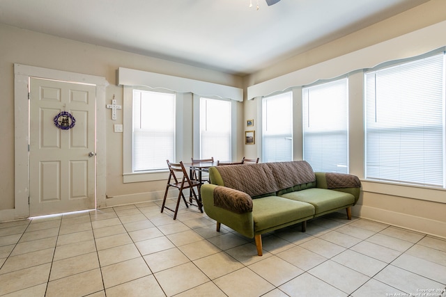 living room with ceiling fan and light tile patterned floors