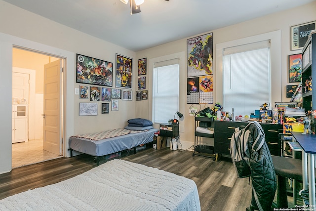 bedroom featuring ceiling fan, dark hardwood / wood-style flooring, and ensuite bathroom