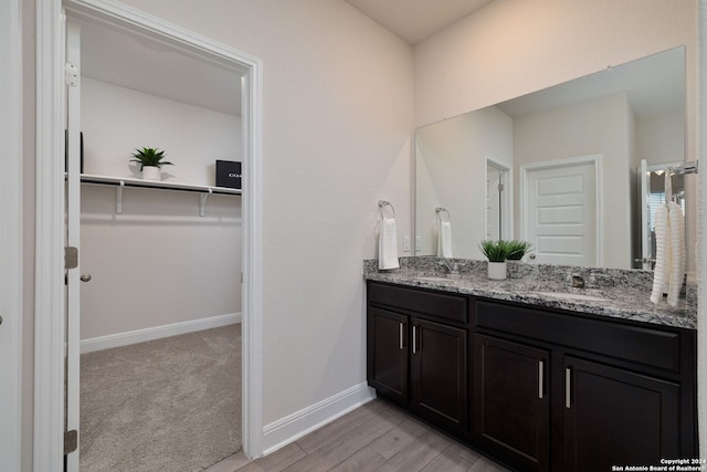 bathroom with vanity and hardwood / wood-style floors