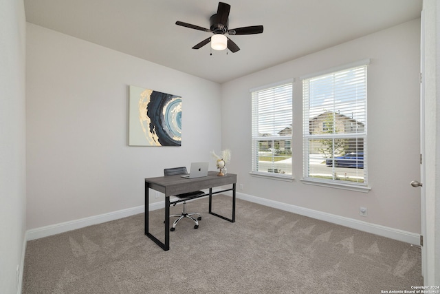 office with light carpet and ceiling fan