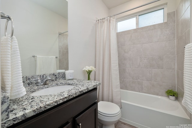 full bathroom featuring vanity, toilet, and shower / bath combination with curtain