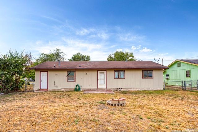 back of property featuring a gate, a yard, a patio, and fence