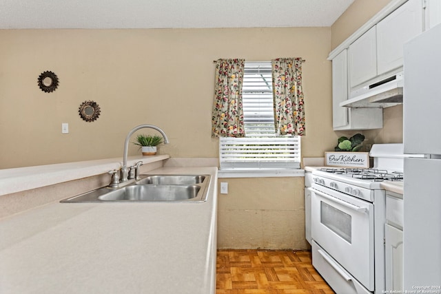 kitchen with light countertops, white appliances, a sink, and under cabinet range hood