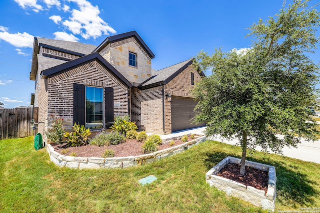 view of front of home featuring a front lawn and a garage