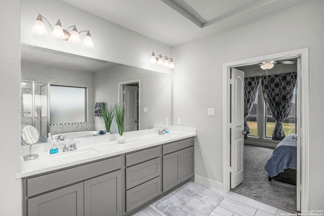 bathroom with a shower with door, vanity, and tile patterned flooring