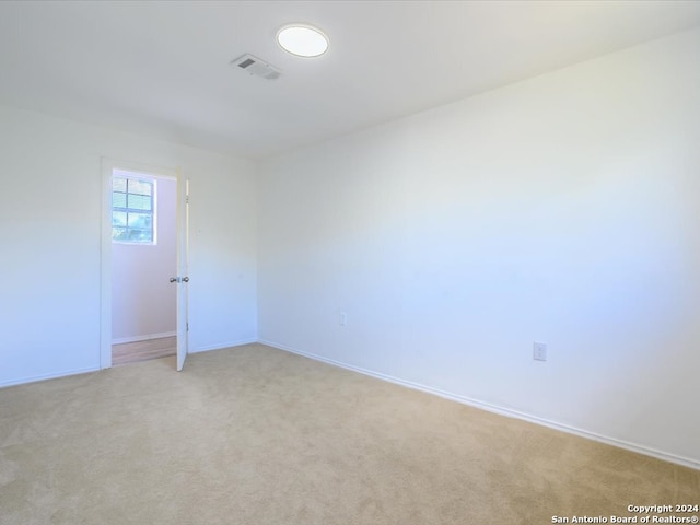 spare room with light carpet