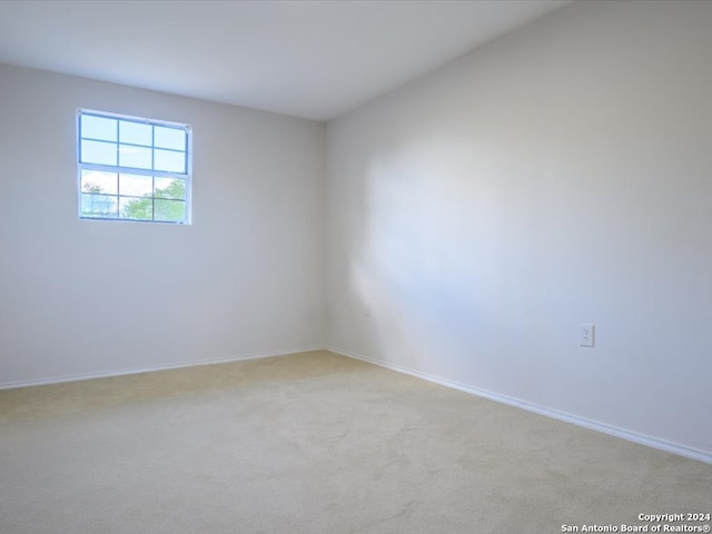 unfurnished room featuring light colored carpet