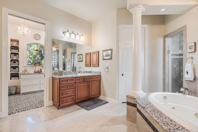 bathroom featuring vanity, an inviting chandelier, independent shower and bath, and decorative columns