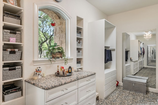 spacious closet with a notable chandelier