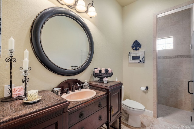 bathroom featuring tile patterned flooring, vanity, toilet, and an enclosed shower