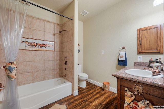 full bathroom with hardwood / wood-style floors, vanity, toilet, and shower / bath combo with shower curtain