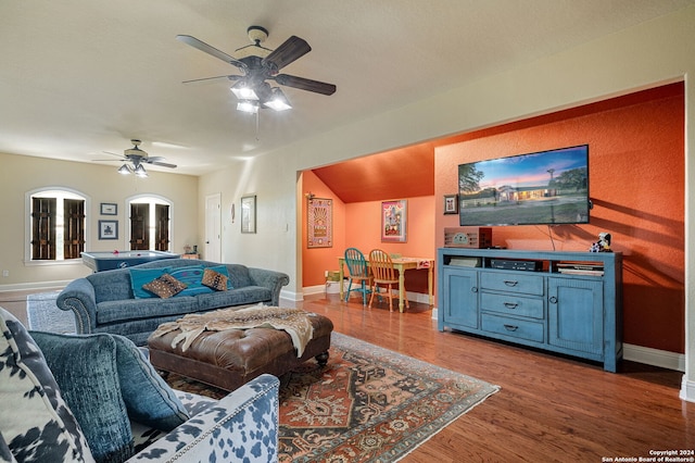 living room featuring hardwood / wood-style floors and ceiling fan