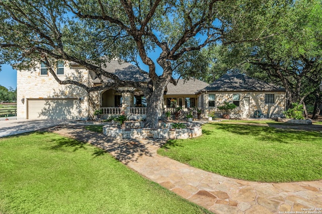 tudor home with a front yard and a garage