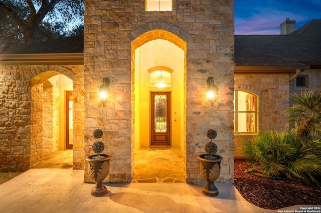 view of exterior entry at dusk