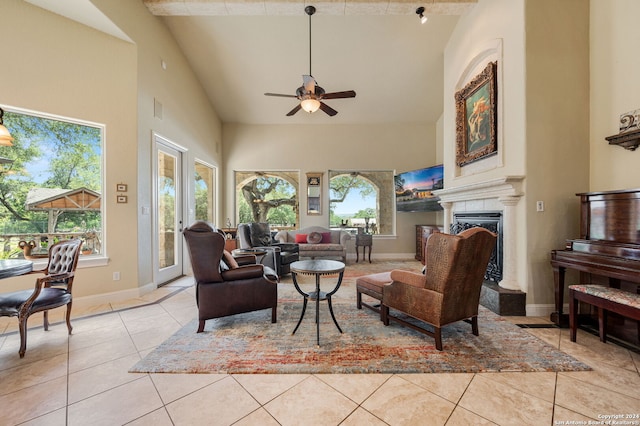 tiled living room featuring high vaulted ceiling and ceiling fan