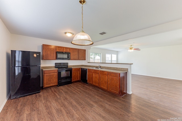 kitchen with dark wood-type flooring, black appliances, ceiling fan, and decorative light fixtures