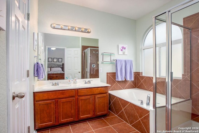 bathroom featuring ensuite bath, tile patterned floors, a sink, a shower stall, and a bath