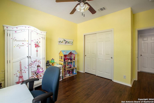 home office featuring a ceiling fan, visible vents, baseboards, and wood finished floors