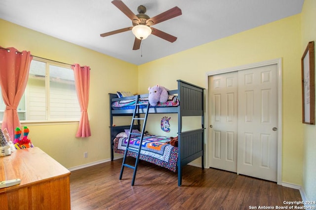 bedroom featuring a closet, dark wood-style flooring, baseboards, and a ceiling fan