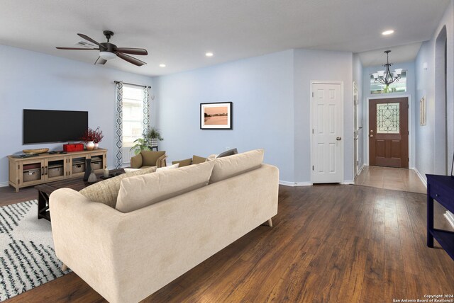 living room featuring a textured ceiling, ceiling fan, and dark hardwood / wood-style flooring