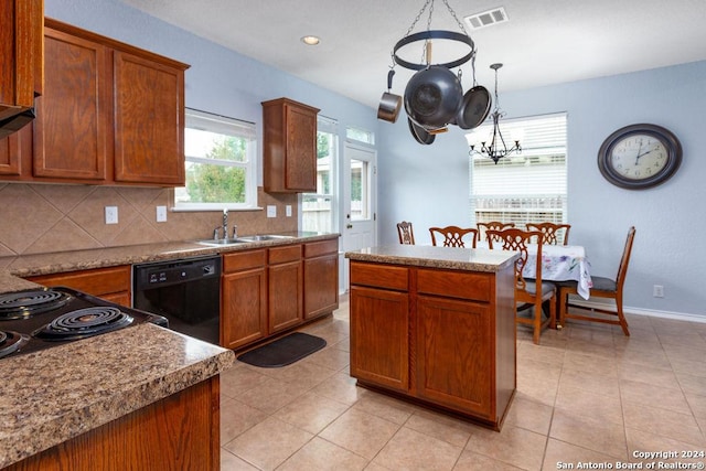 kitchen featuring black dishwasher, brown cabinets, visible vents, backsplash, and a sink