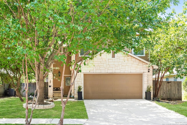 view of front of property featuring a garage and a front lawn