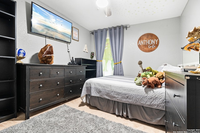 bedroom with ceiling fan and carpet floors