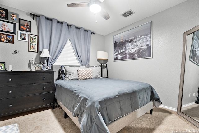 bedroom with ceiling fan and light carpet