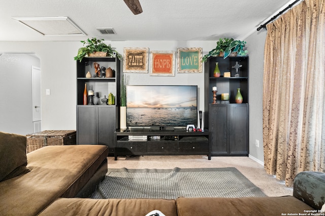 living room featuring a textured ceiling and carpet flooring