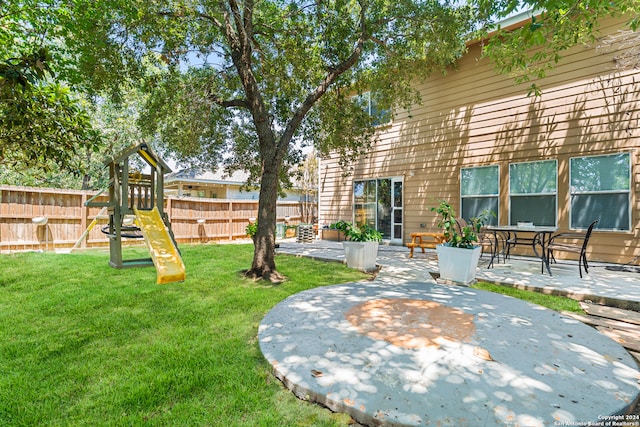 view of yard with a playground and a patio