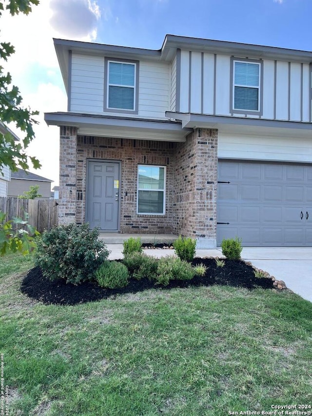 view of front facade featuring a garage and a front yard