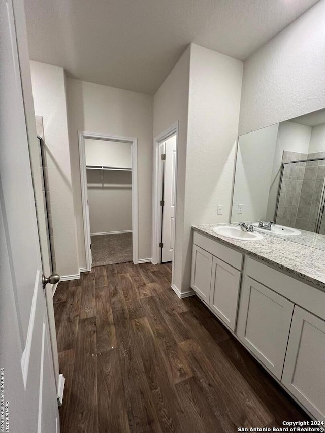 bathroom featuring hardwood / wood-style floors, an enclosed shower, and vanity