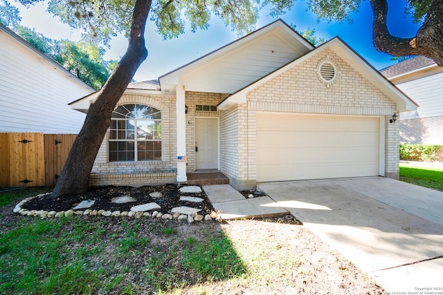 single story home with an attached garage, driveway, fence, and brick siding