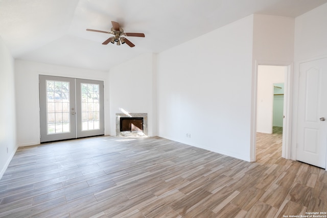 unfurnished living room with ceiling fan, french doors, and light hardwood / wood-style floors